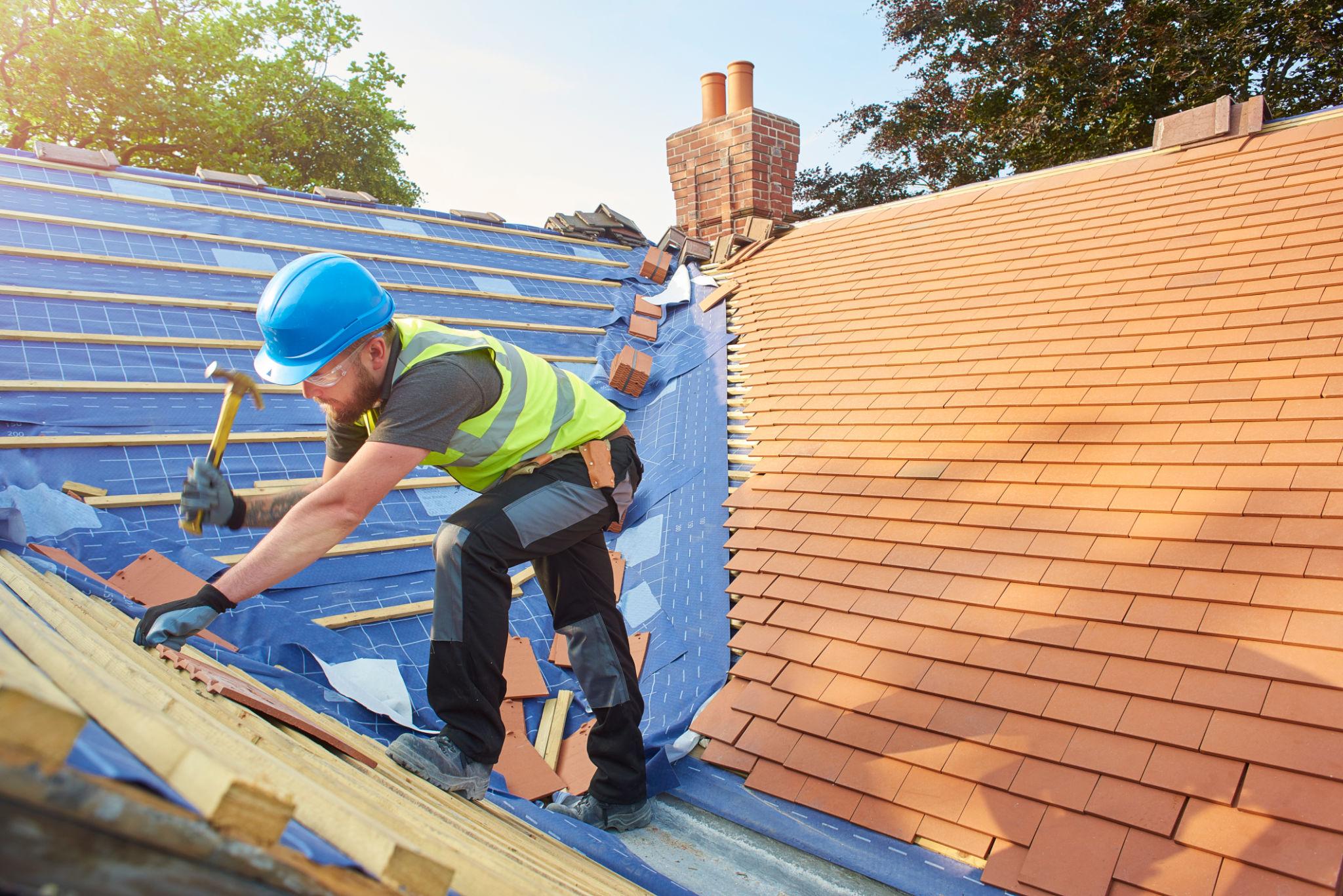 A man working Tile Roof Replacement