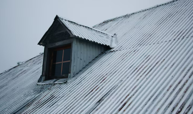 Snow-covered roof under a cloudy sky