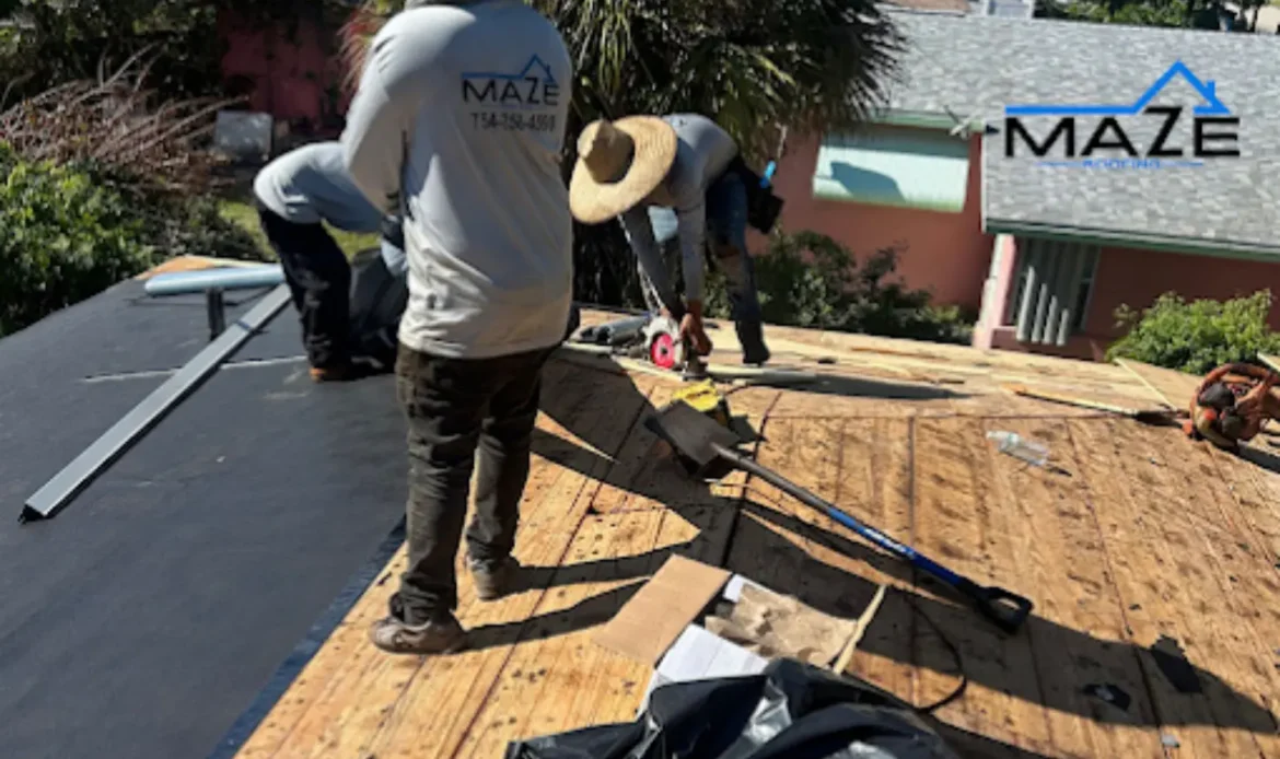 Roof workers installing protective roofing material.