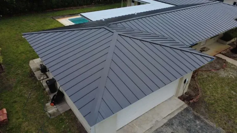 Drone view of a modern black standing seam metal roof on a residential home.
