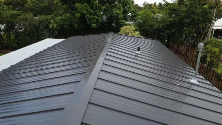 Close up view of a black standing seam metal roof installation on a residential property.