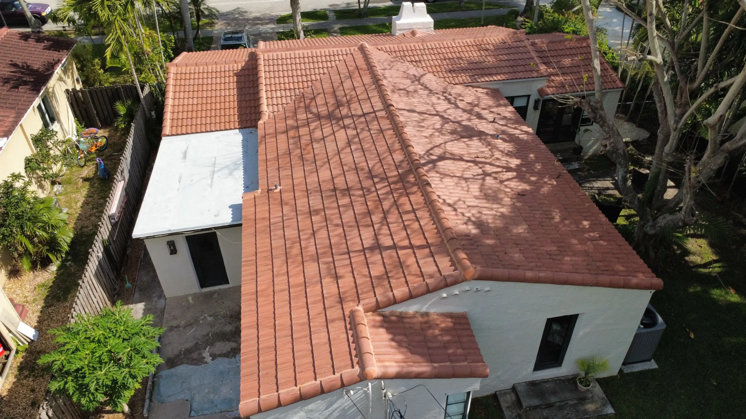 Close aerial view of tiled roof and backyard