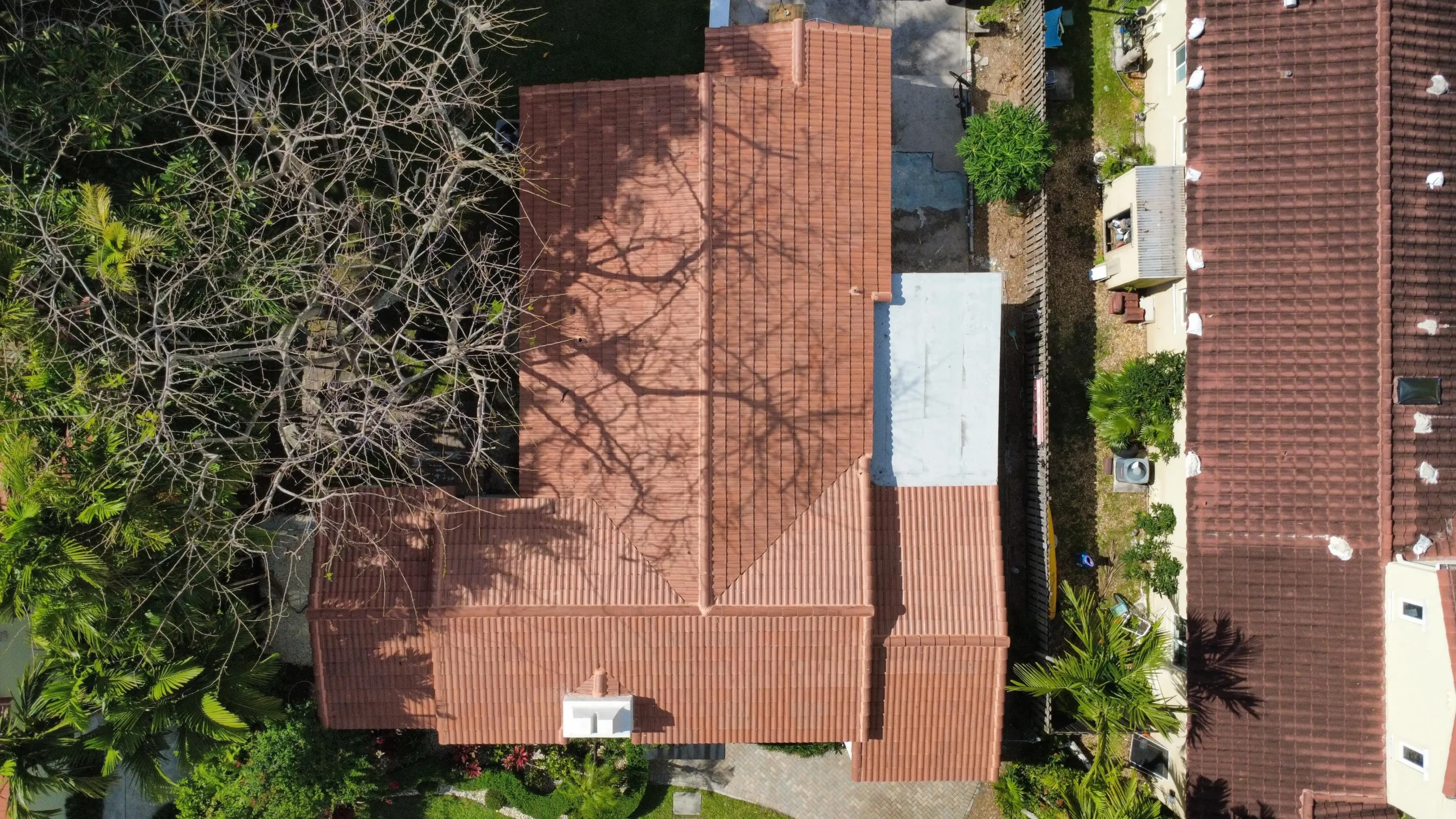 Bird’s-eye view of house roof with tree shadows