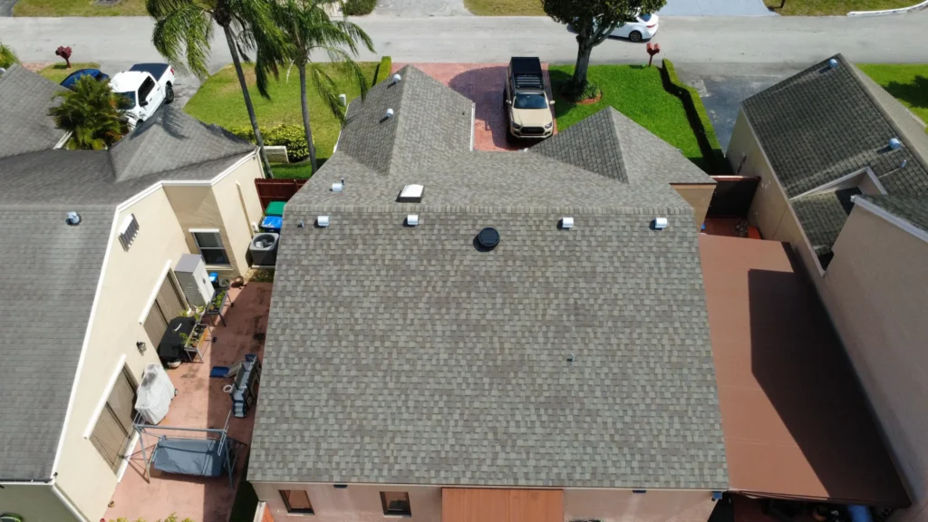 Overhead drone view of newly installed residential shingle roof.