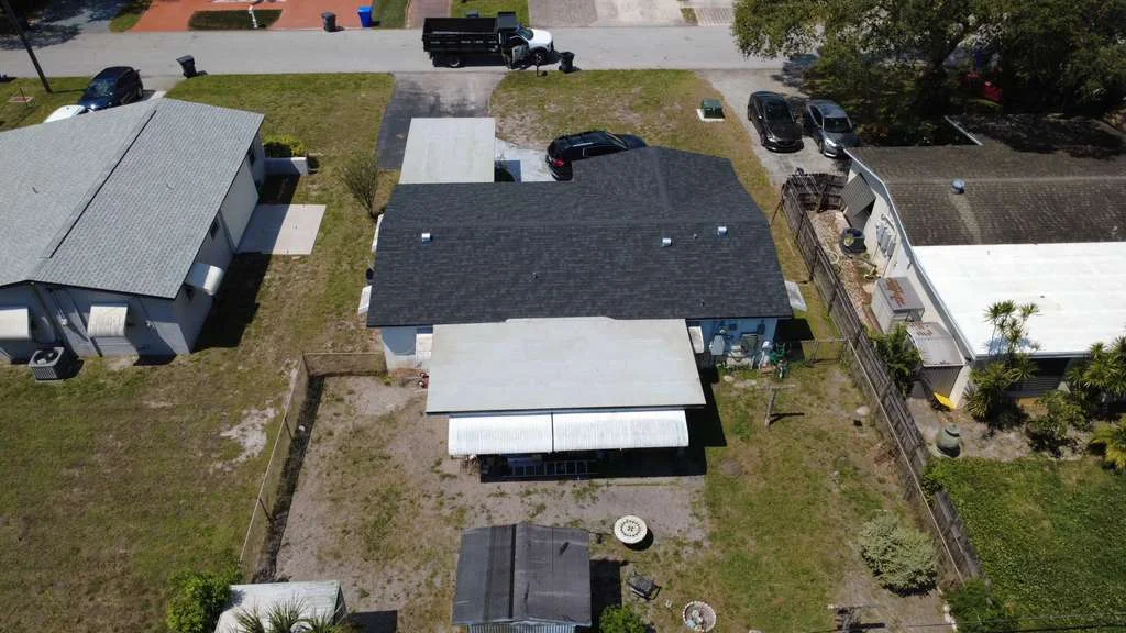 Top aerial view of a completed black architectural shingle roof