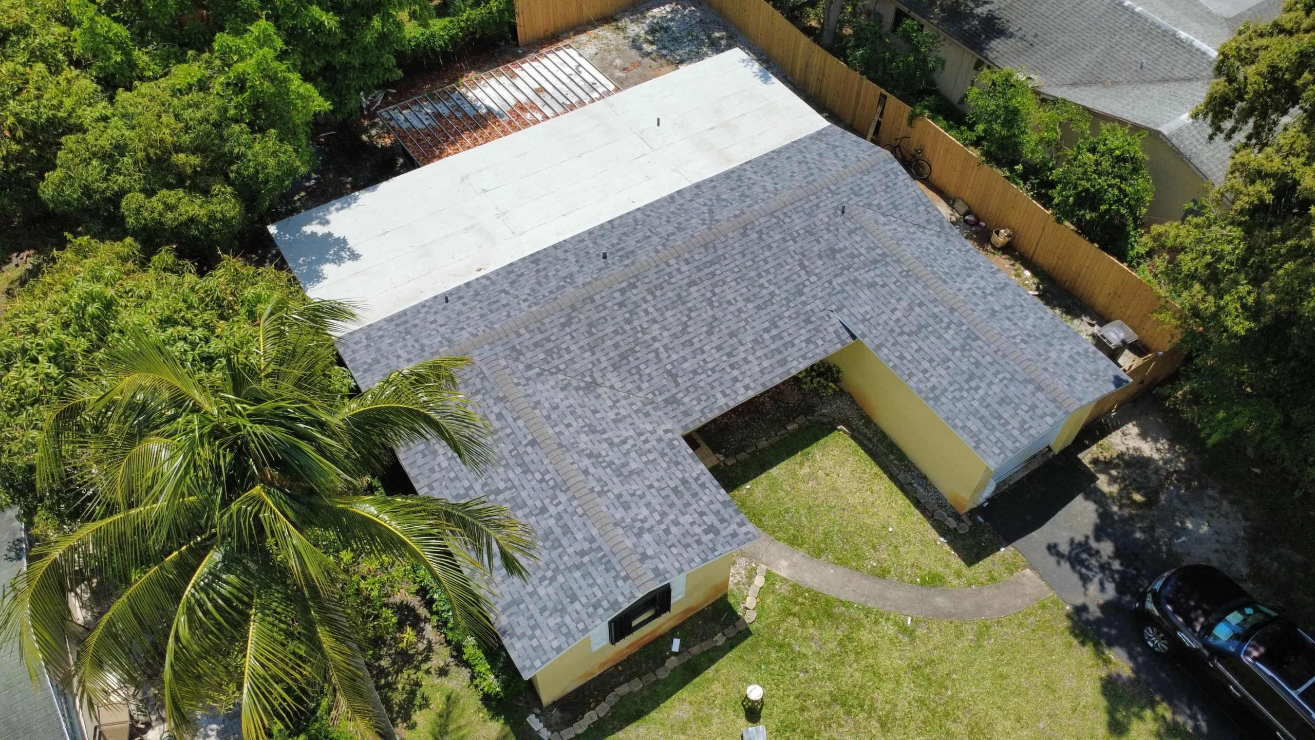 Aerial perspective of a completed residential gray shingle roof