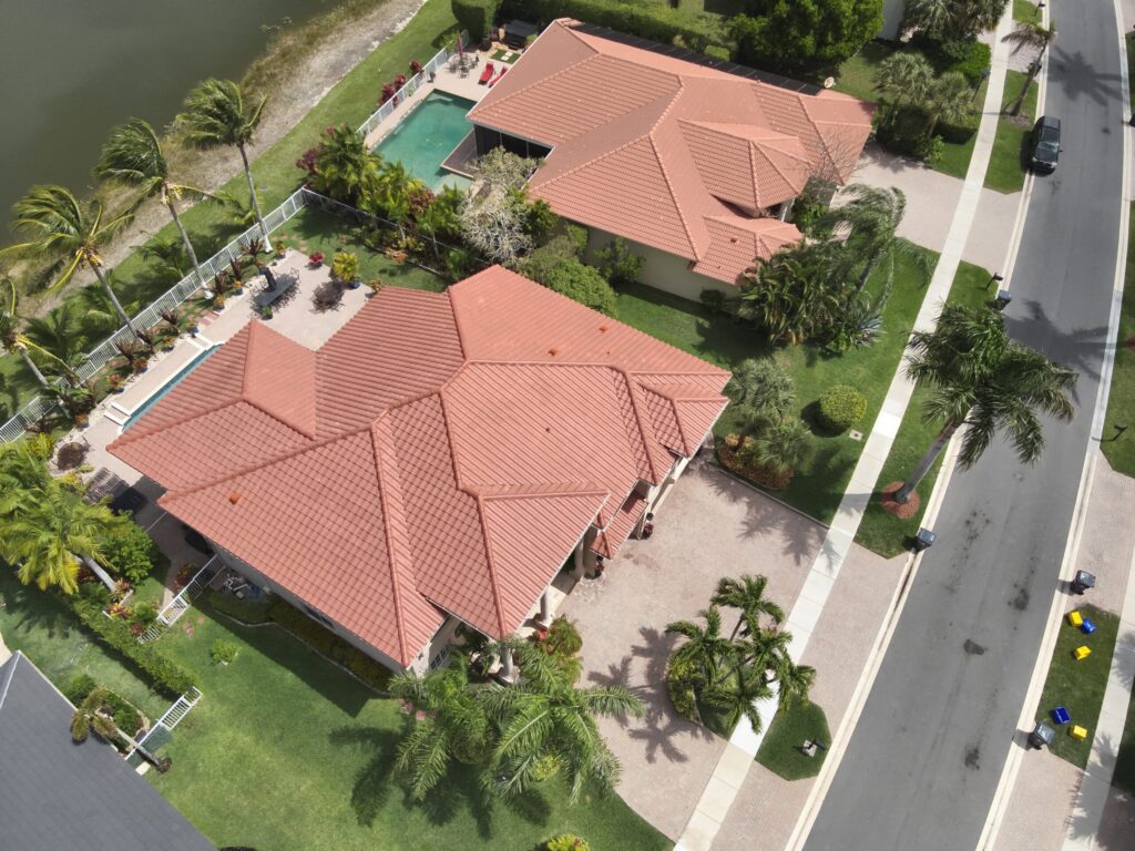 Aerial view of houses with red tile roofs and pool