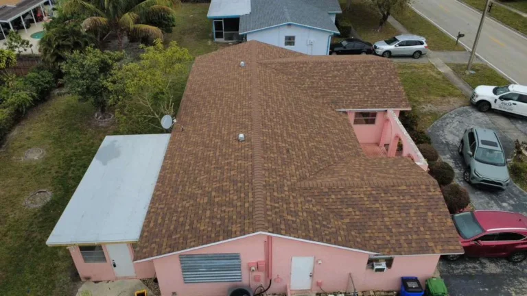 Side aerial view of completed architectural shingle roof.