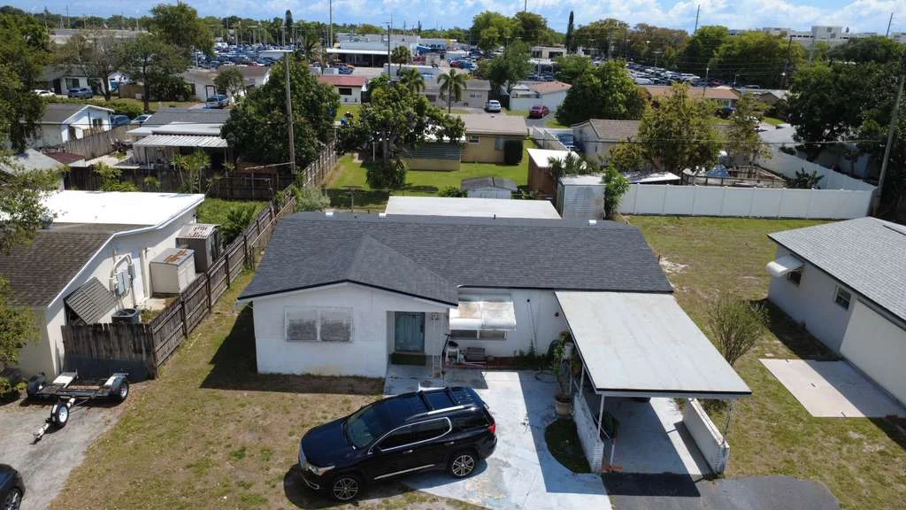 Front aerial view of a completed black asphalt shingle roof