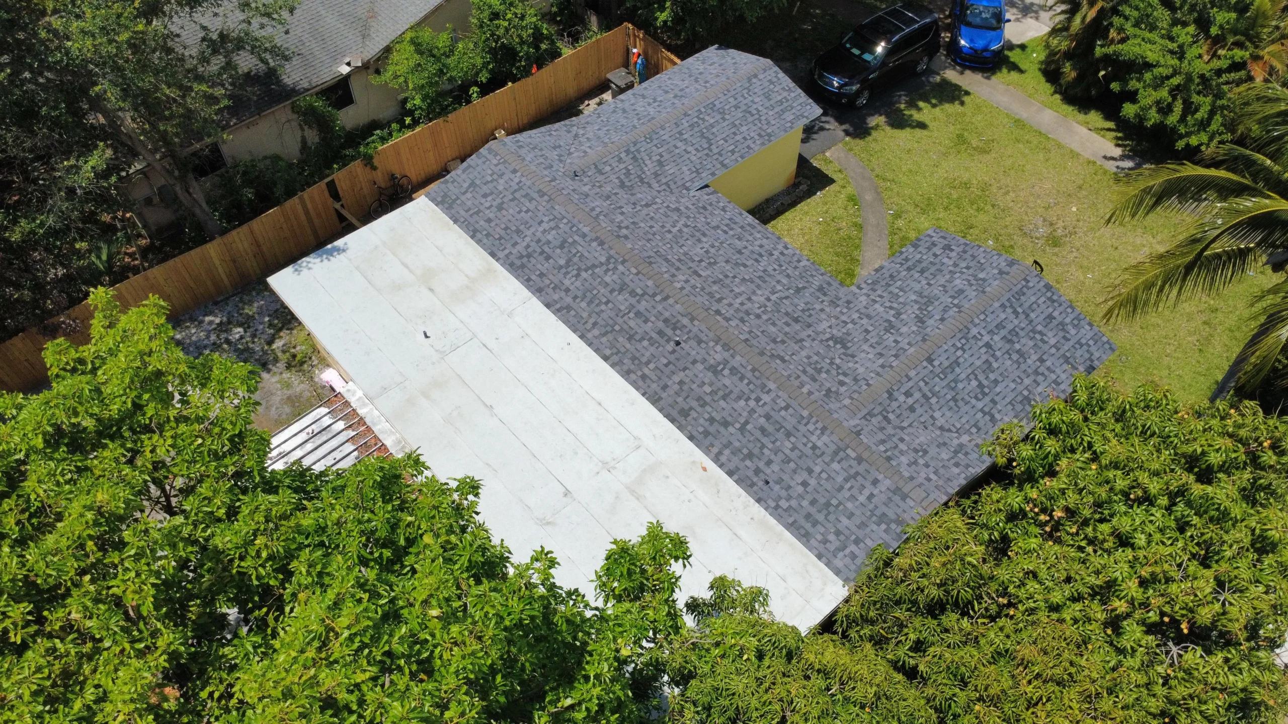 Angled aerial view of a completed gray asphalt shingle roof