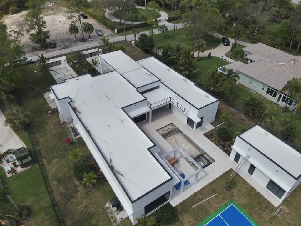 Drone view of a flat roof during an aerial roof inspection by Maze Roofing in Parkland, Florida