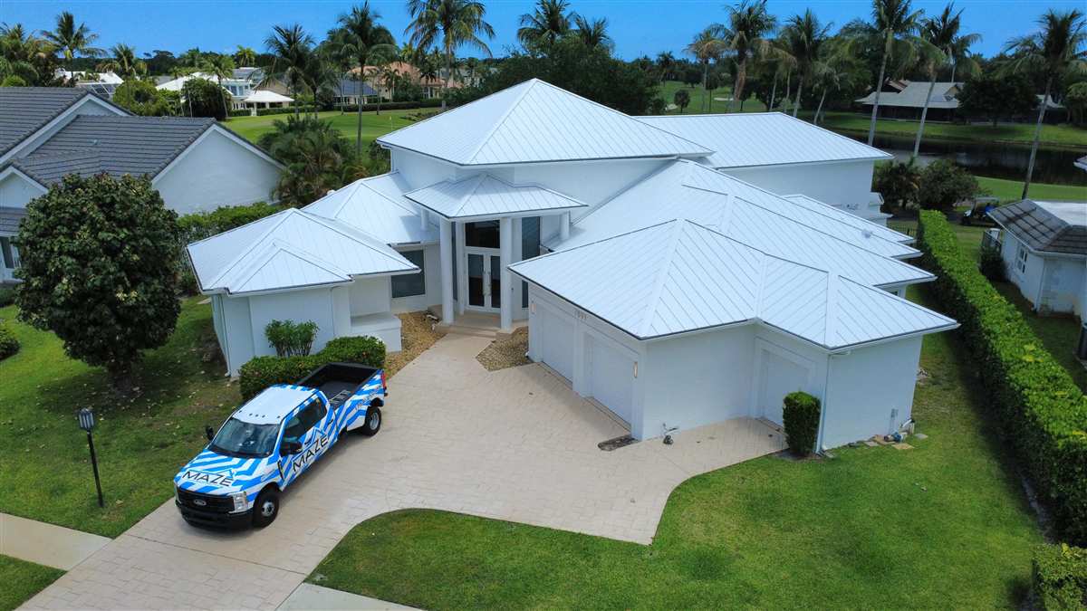Completed 24-gauge standing seam metal roof in Regal White by Maze Roofing in Boca Raton, Florida