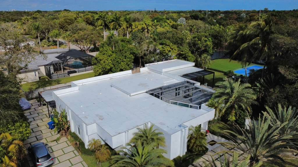 Completed white flat membrane roof installed by Maze Roofing on a home in Cutler Bay, Florida