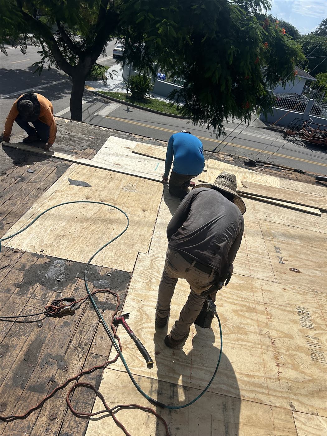 Maze Roofing crew members installing new roof decking on a South Florida home