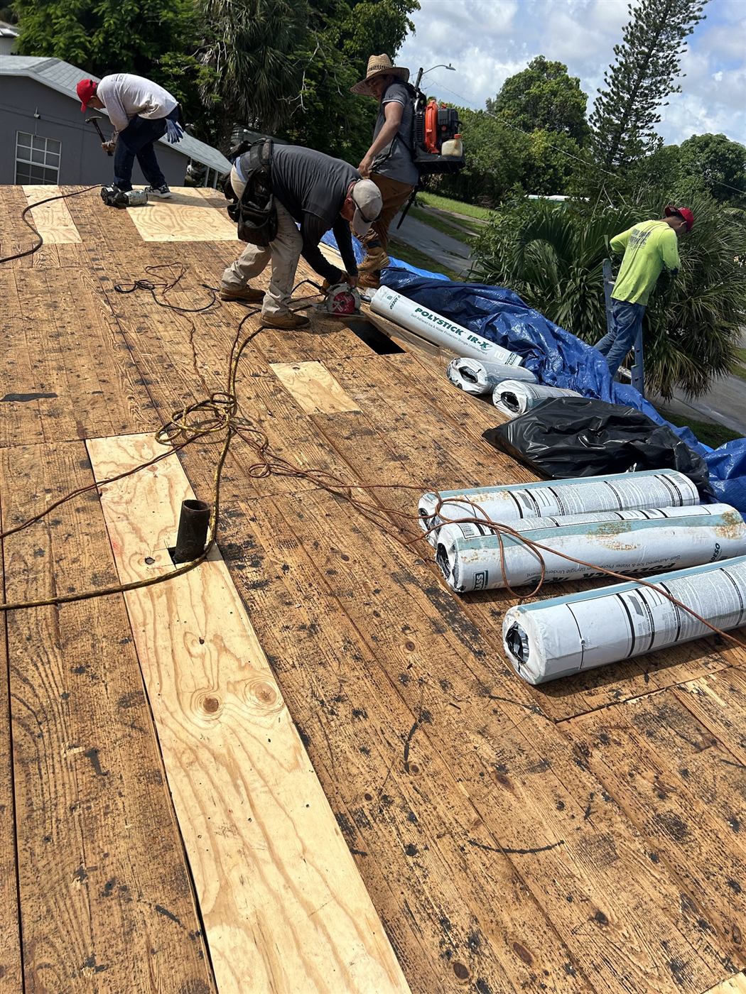 Maze Roofing crew laying new underlayment during a South Florida roof replacement