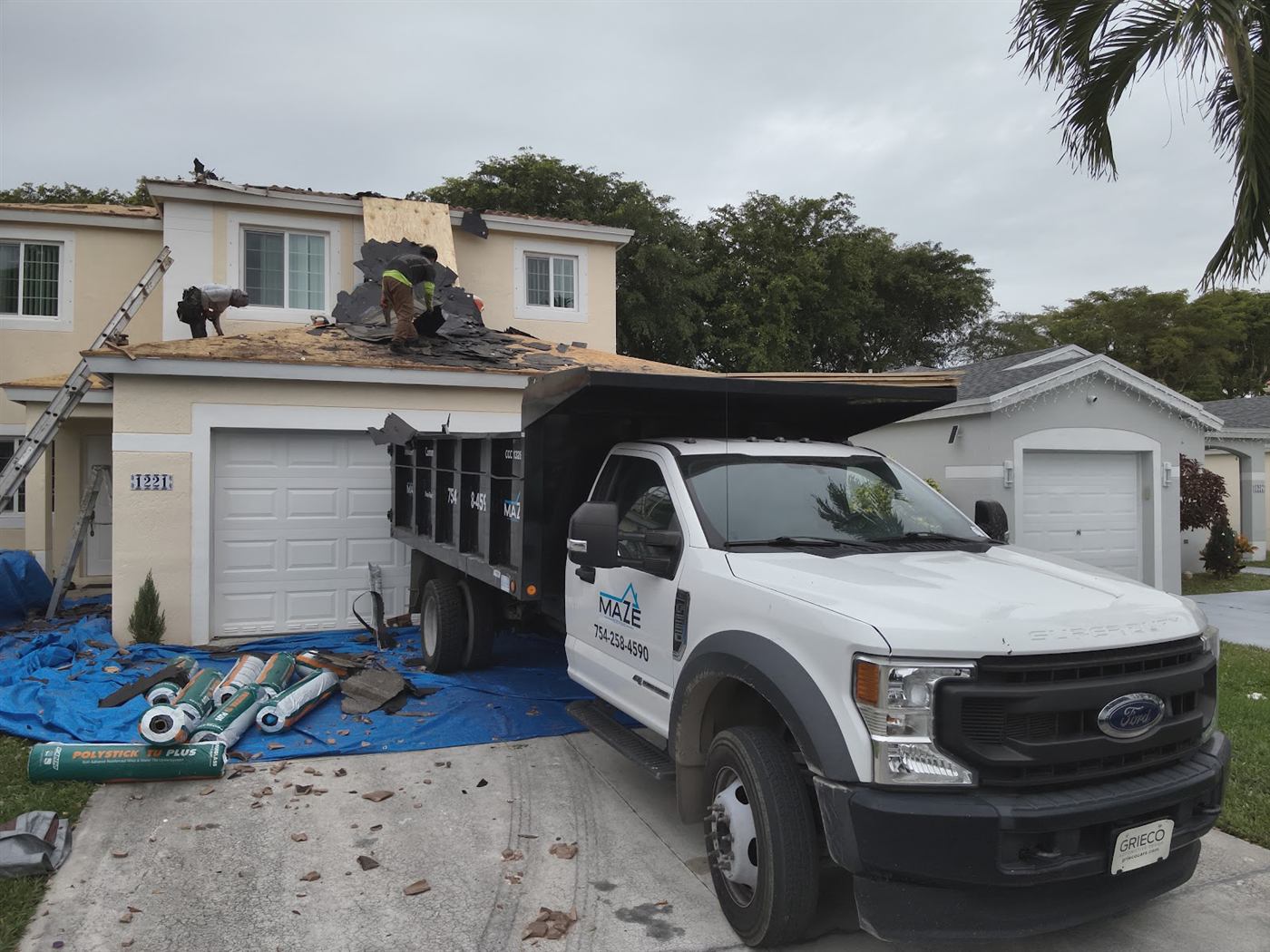 A Maze Roofing truck parked at a residential roof replacement job in South Florida