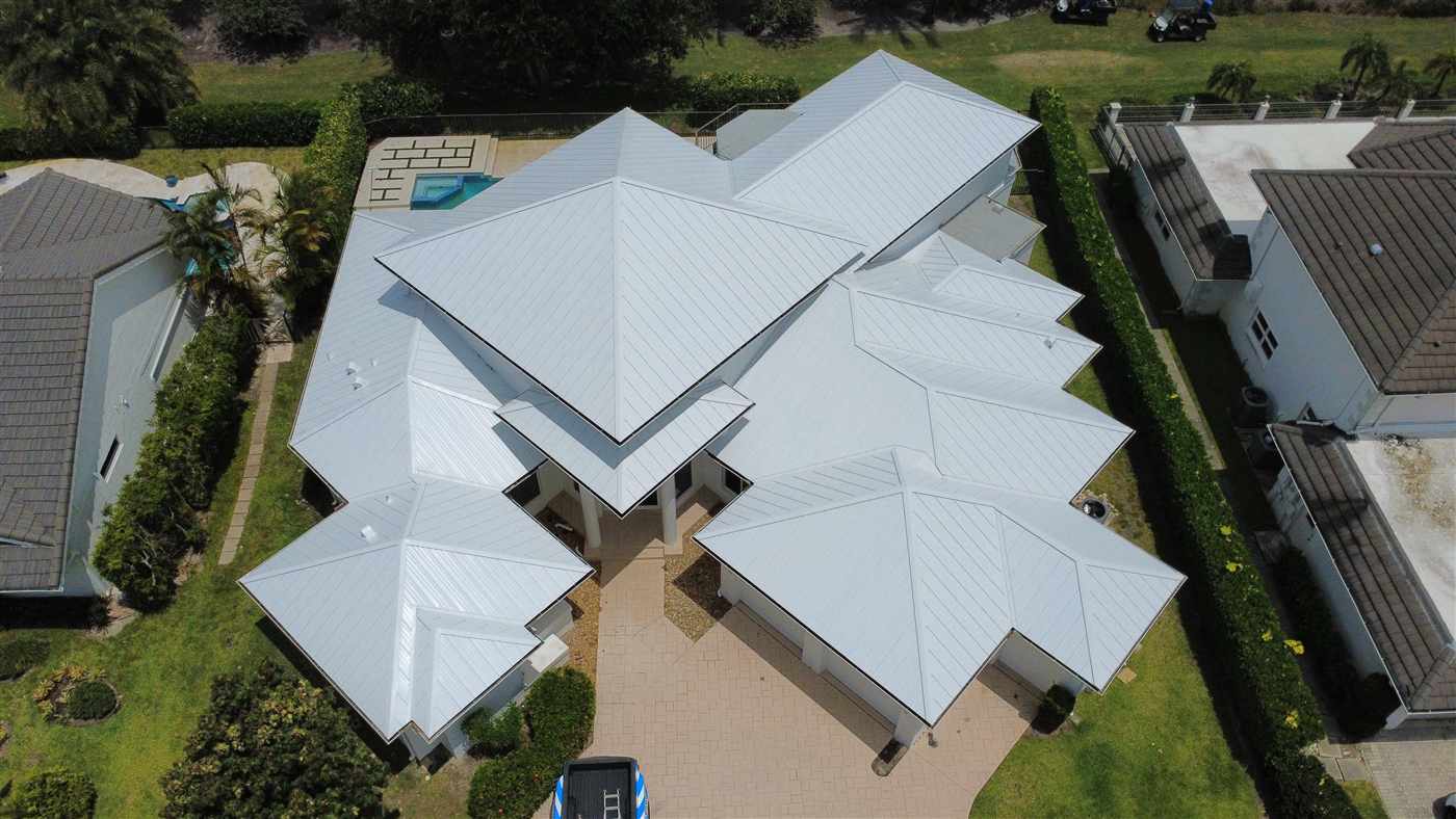 New 24-gauge standing seam metal roof in Regal White installed by Maze Roofing on a home in Boca Raton, Florida