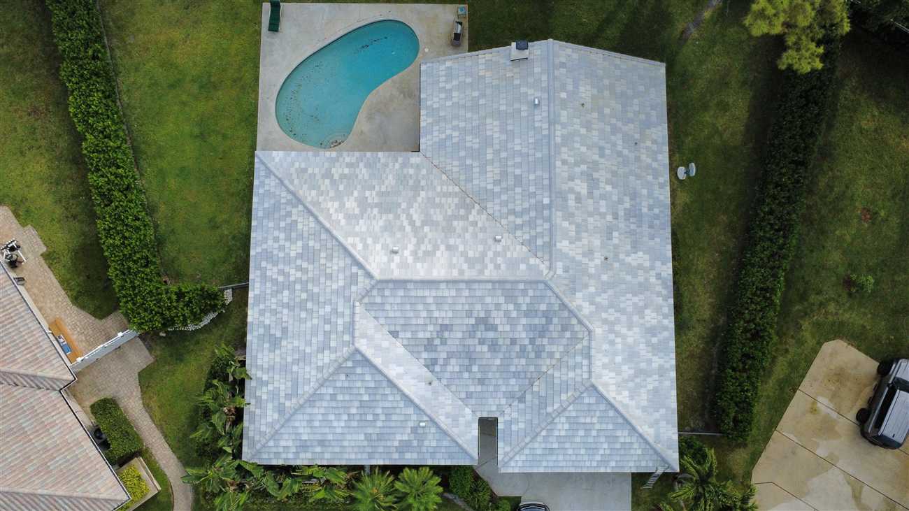 Overhead view of a completed SAXONY 900 Slate tile roof in Mottled White Blend by Maze Roofing in Boca Raton, Florida