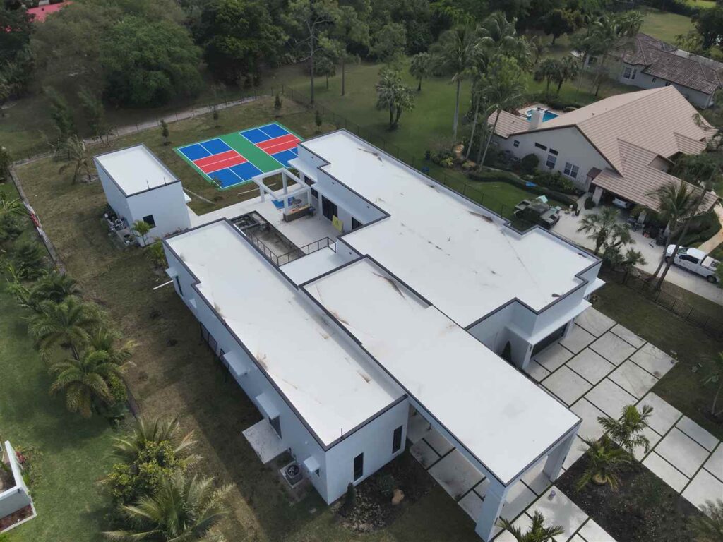 Completed white TPO flat roof installed by Maze Roofing on a property in Parkland, Florida Completed white TPO flat roof installed by Maze Roofing on a property in Parkland, Florida