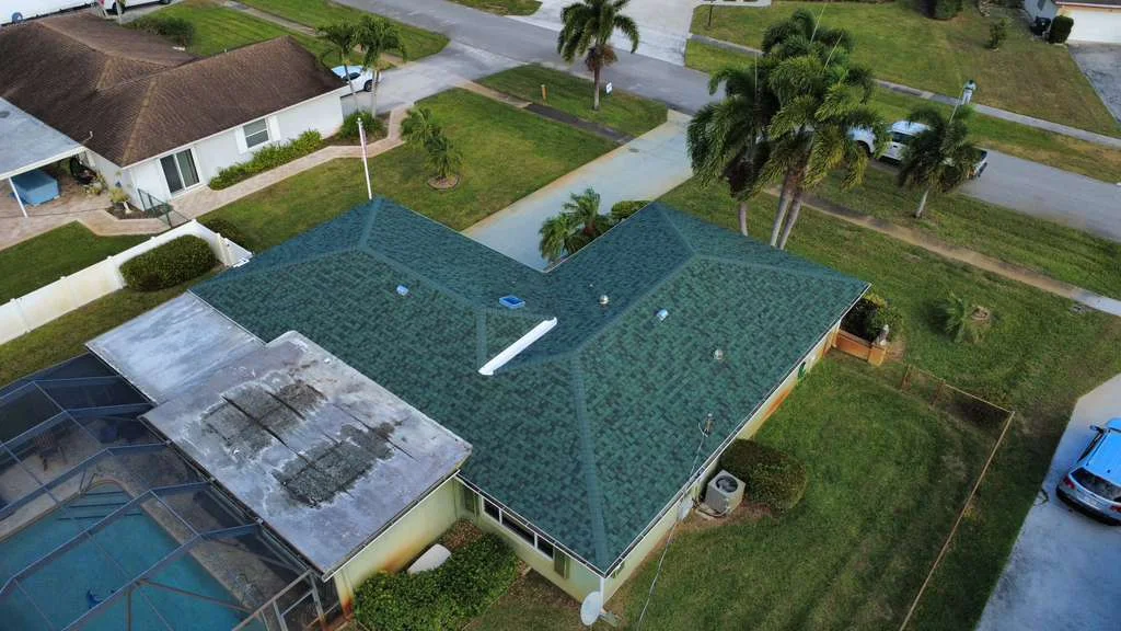 Residential roof replacement with green asphalt shingles