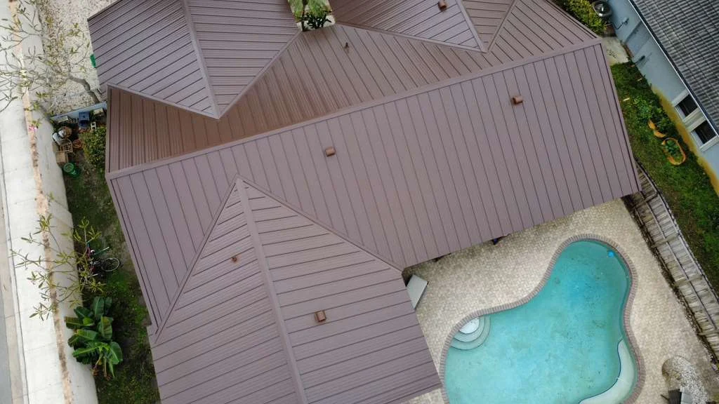 Brown metal roof above backyard pool