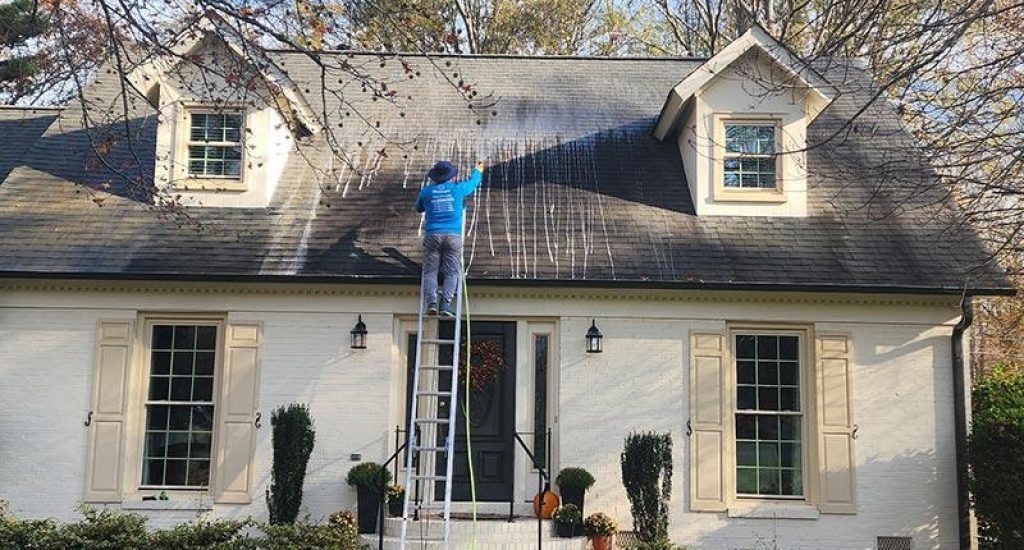 A conratctor cleaning a roof