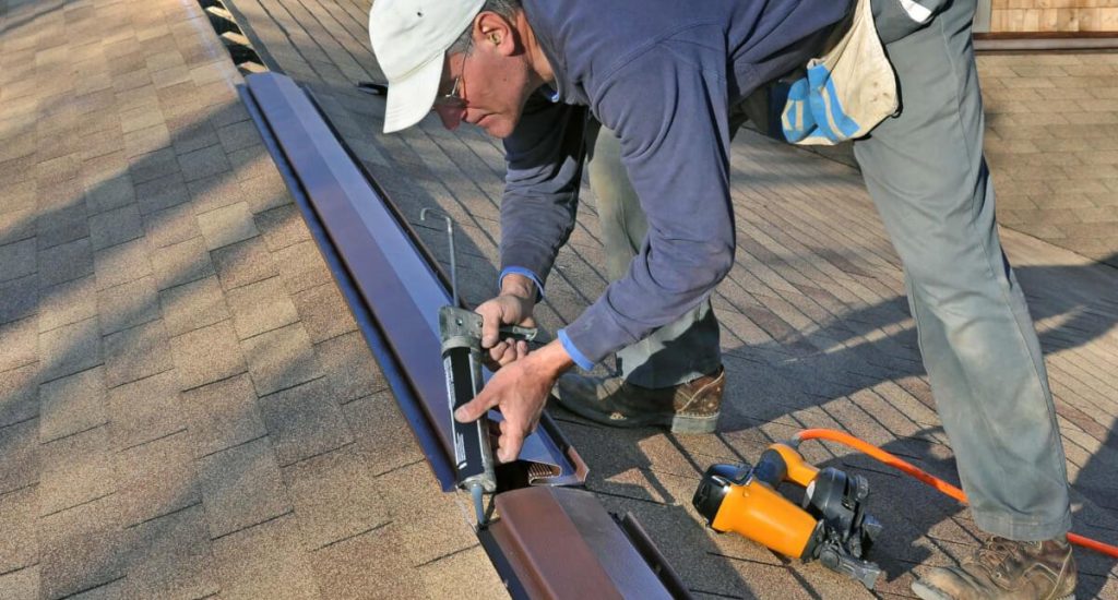 A man working Roof Ridge Cap Replacement