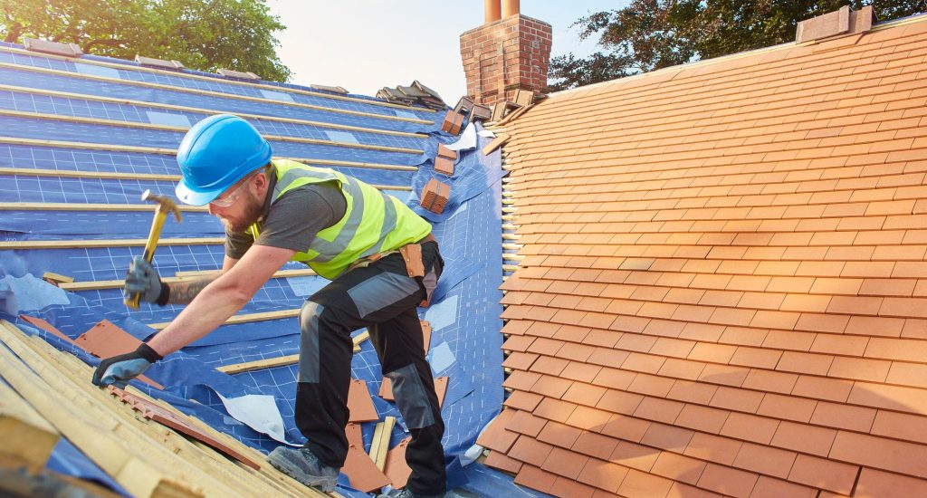 A man working Tile Roof Replacement